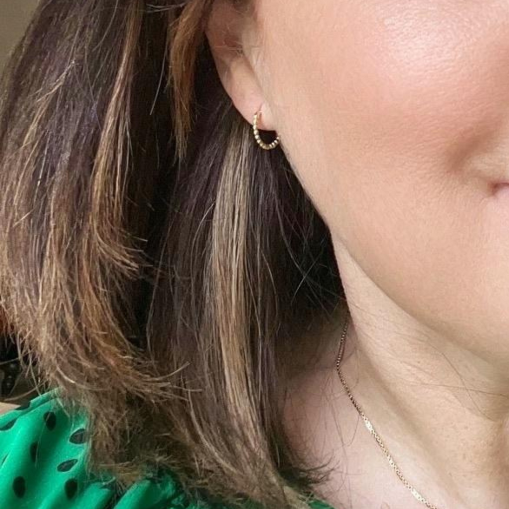  brunette modelling beaded huggie earrings by Misia Mae