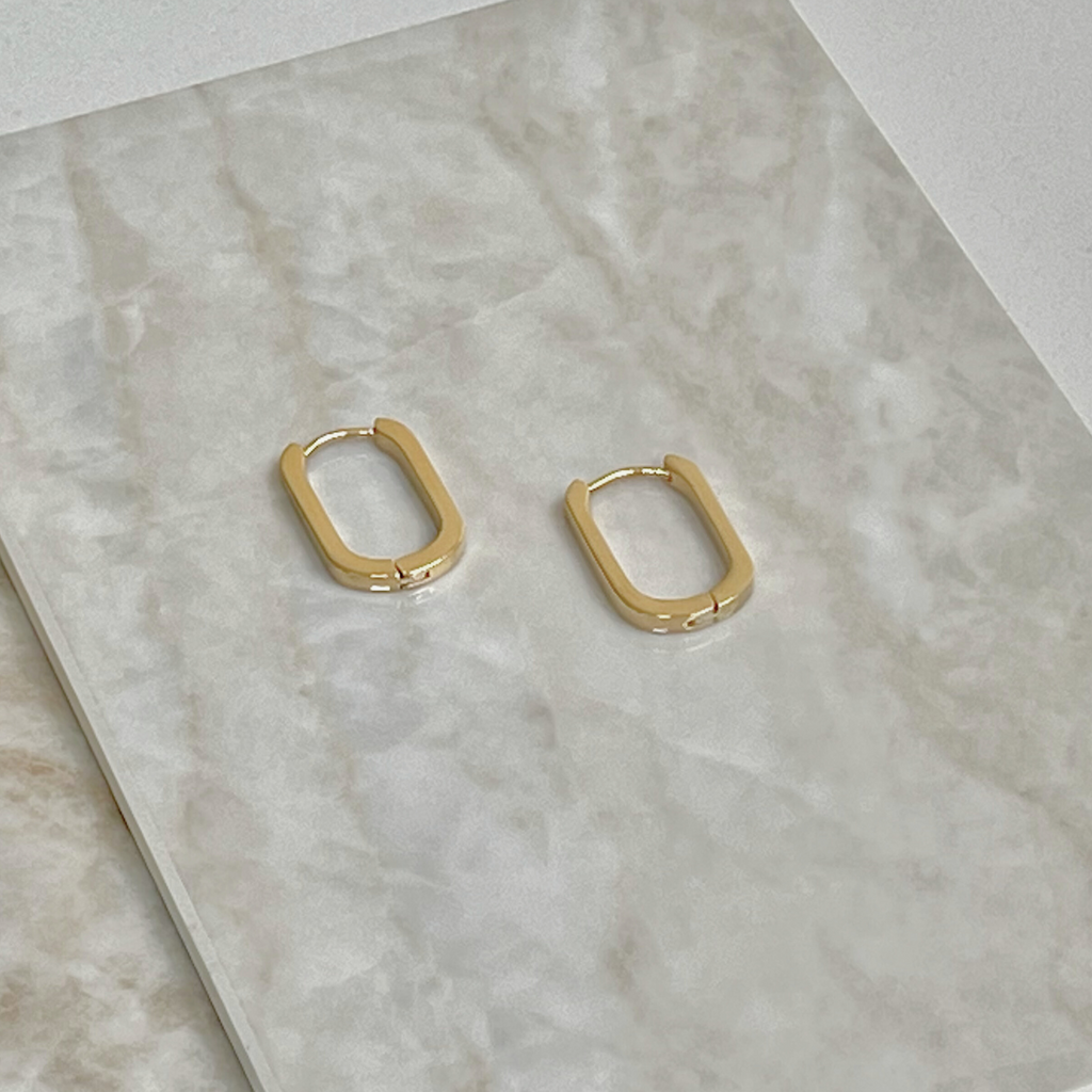 Gold oval earrings by Misia Mae