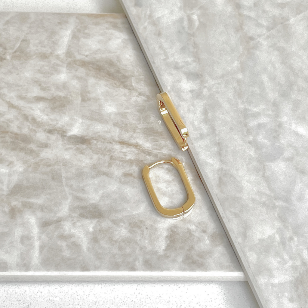Gold oval earrings by Misia Mae