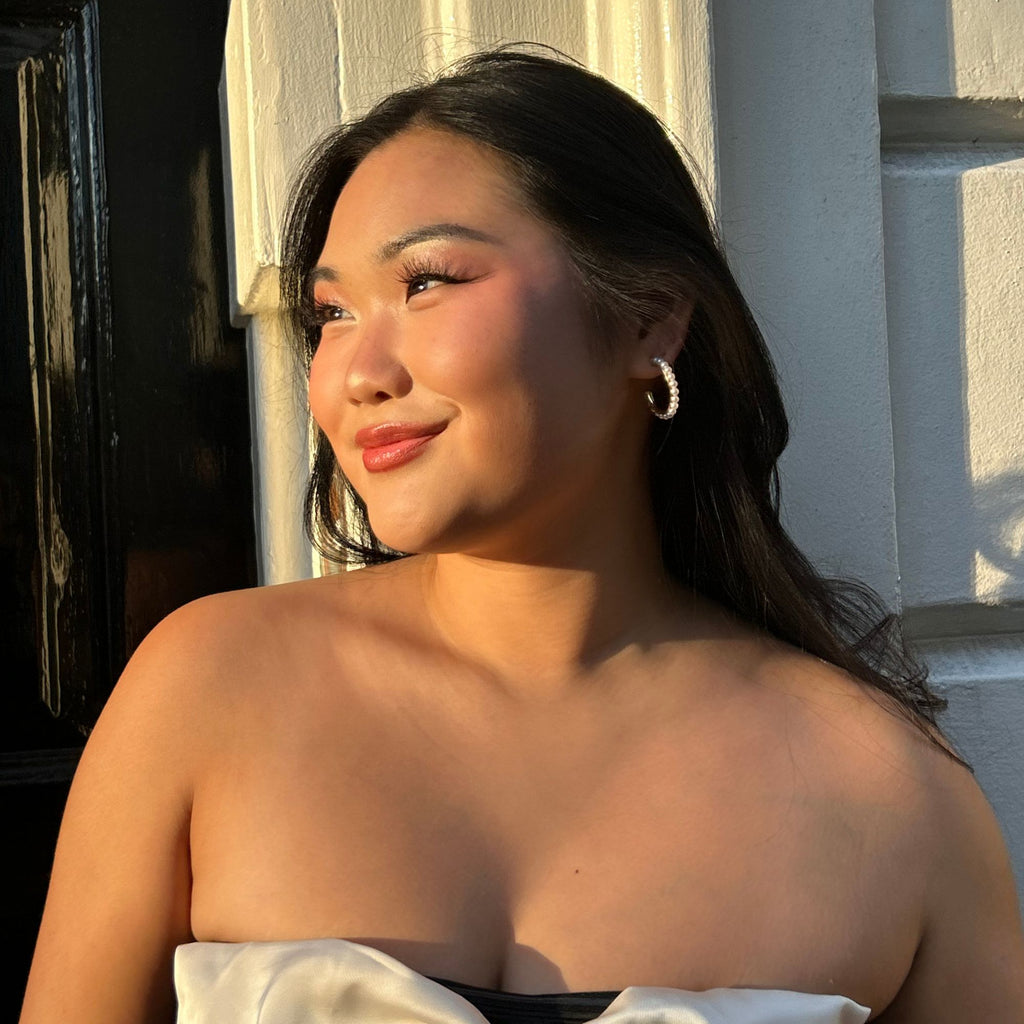 a brunette woman wearing pearl hoop earrings by |Misia Mae