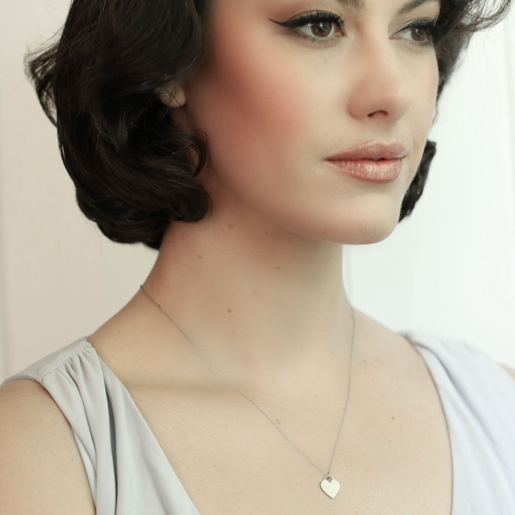 Dainty silver heart necklace - Misia Mae London on a dark heard woman